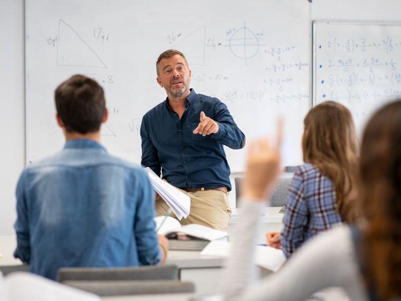 Image of a university tutor answering a student question during lesson